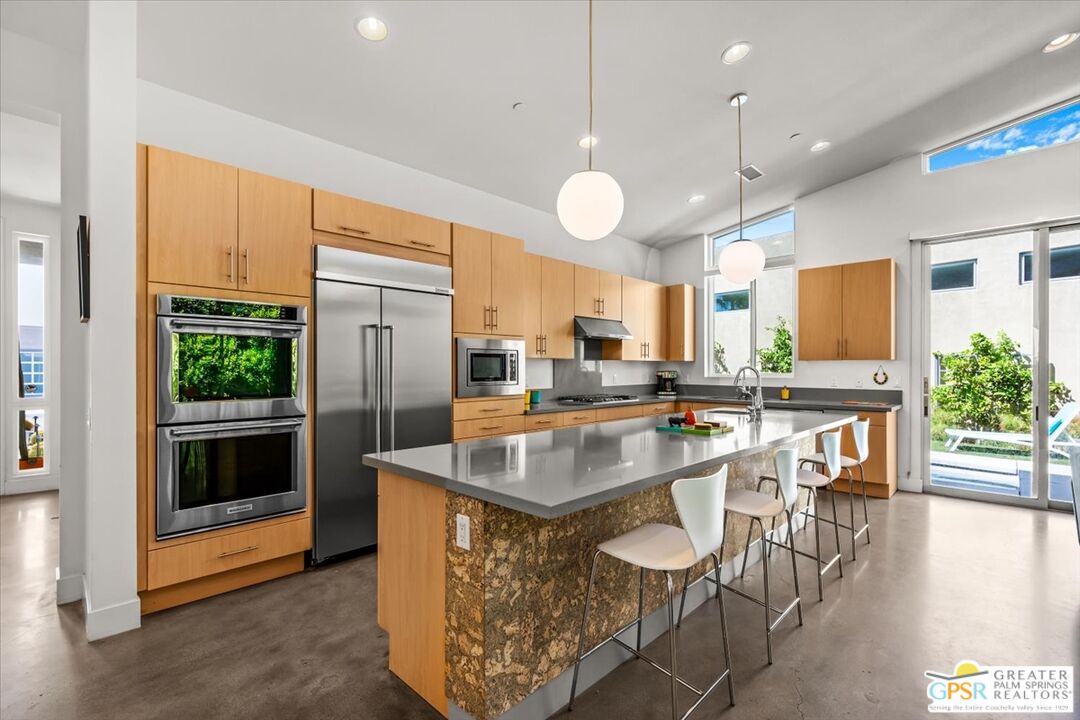 4201 Amber Lane Palm Springs, CA 92262 - Photo 12 of 55 a kitchen with stainless steel appliances granite countertop a sink a stove and a refrigerator