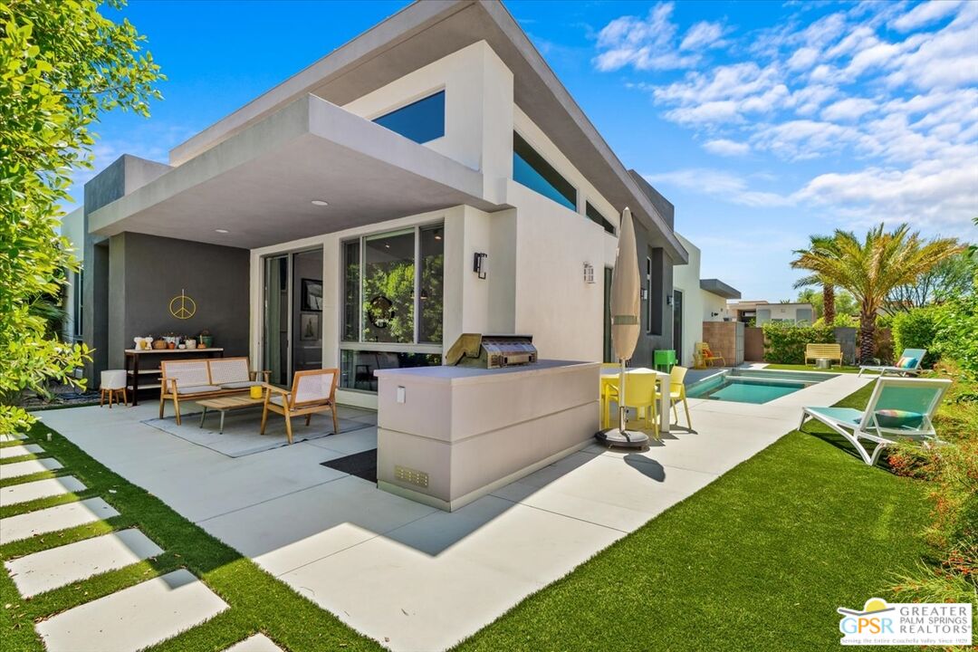 4201 Amber Lane Palm Springs, CA 92262 - Photo 41 of 55 a swimming pool with outdoor seating and a garden