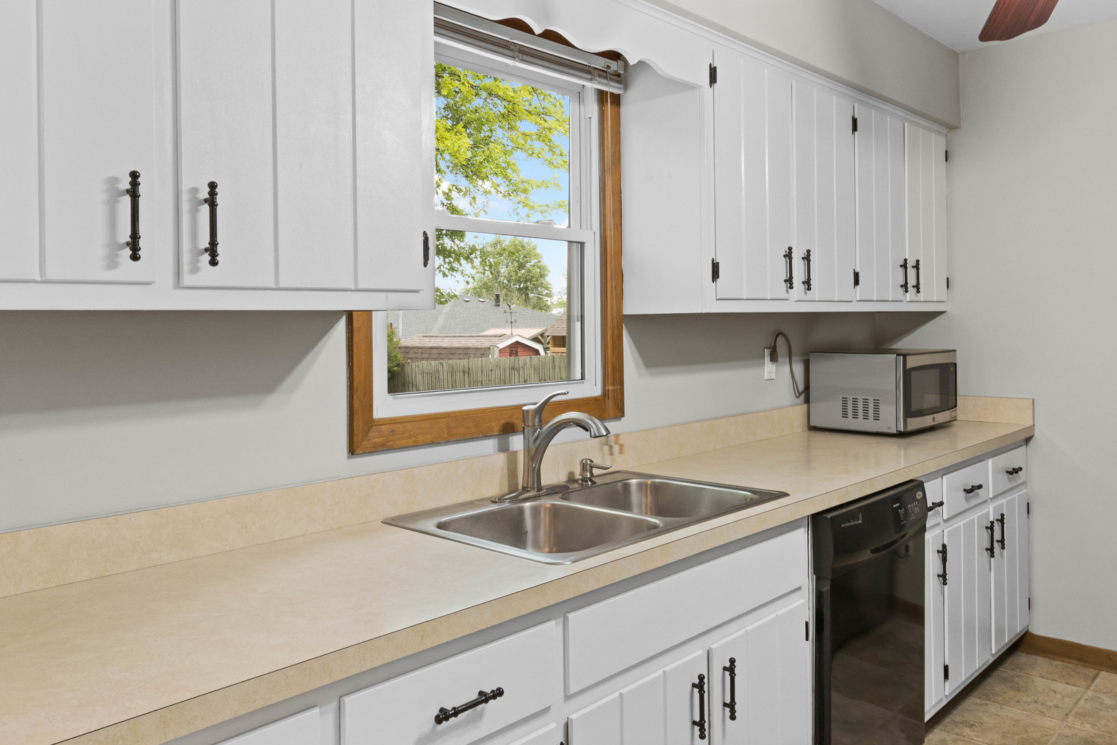 1010 Southgate Road New Lenox, IL 60451 - Photo 8 of 30 a kitchen with stainless steel appliances granite countertop a sink and a white cabinets
