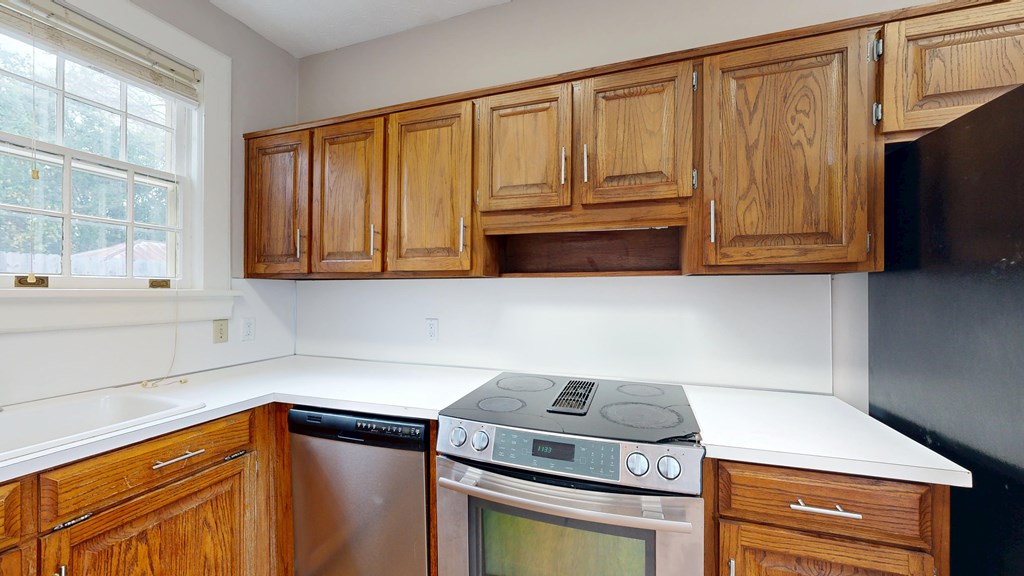 1237 Peacock Avenue Columbus, GA 31906 - Photo 11 of 52 a kitchen with stainless steel appliances granite countertop white cabinets and a stove top oven