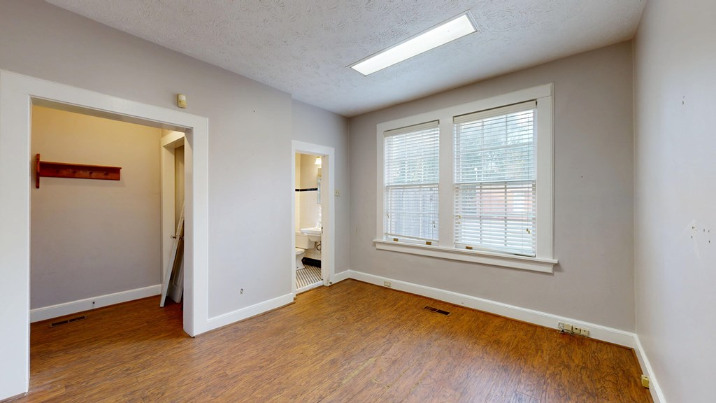 1237 Peacock Avenue Columbus, GA 31906 - Photo 16 of 52 an empty room with wooden floor and windows