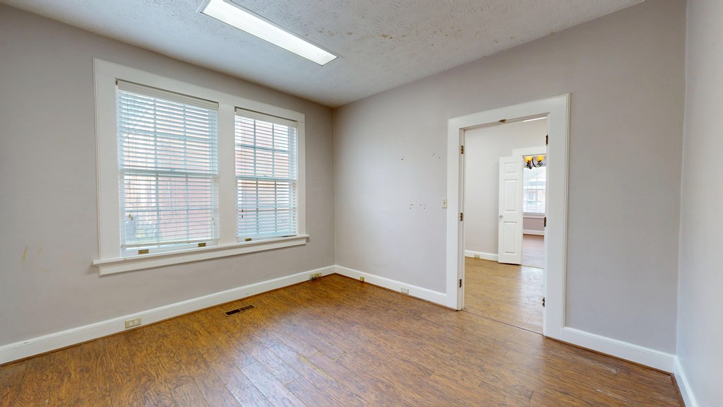 1237 Peacock Avenue Columbus, GA 31906 - Photo 17 of 52 an empty room with wooden floor and windows