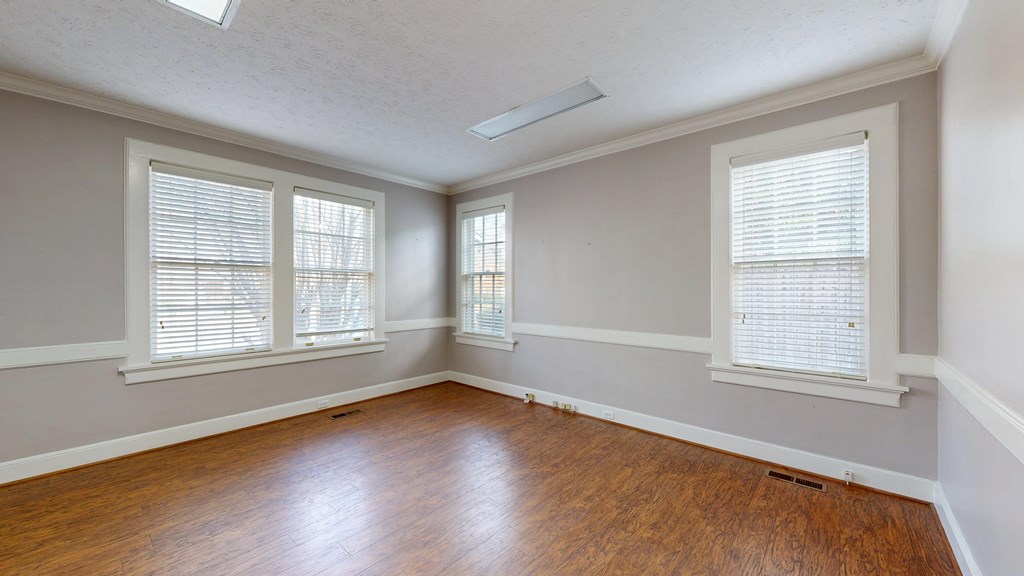 1237 Peacock Avenue Columbus, GA 31906 - Photo 19 of 52 an empty room with wooden floor and windows