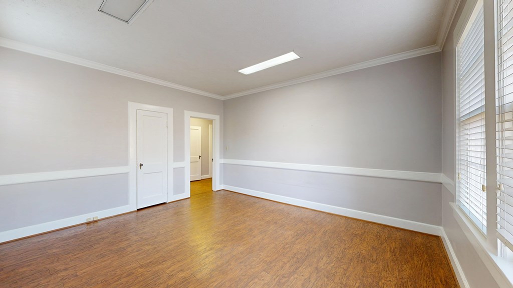 1237 Peacock Avenue Columbus, GA 31906 - Photo 20 of 52 an empty room with wooden floor and windows
