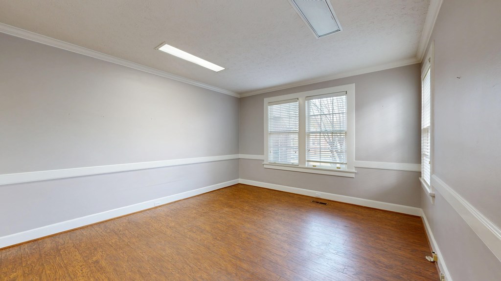 1237 Peacock Avenue Columbus, GA 31906 - Photo 21 of 52 an empty room with wooden floor and windows