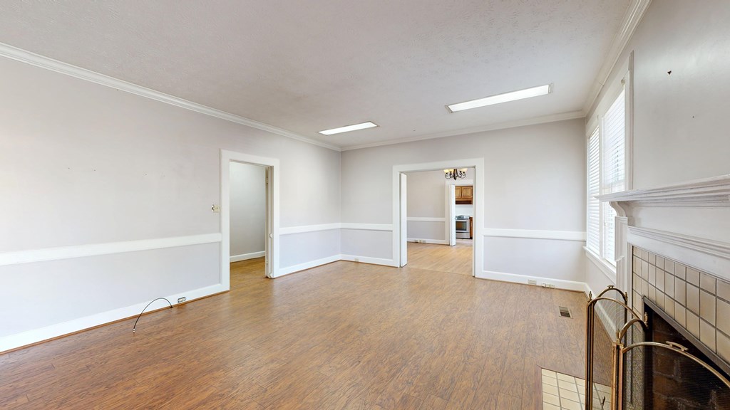 1237 Peacock Avenue Columbus, GA 31906 - Photo 4 of 52 wooden floor in an empty room with a fireplace