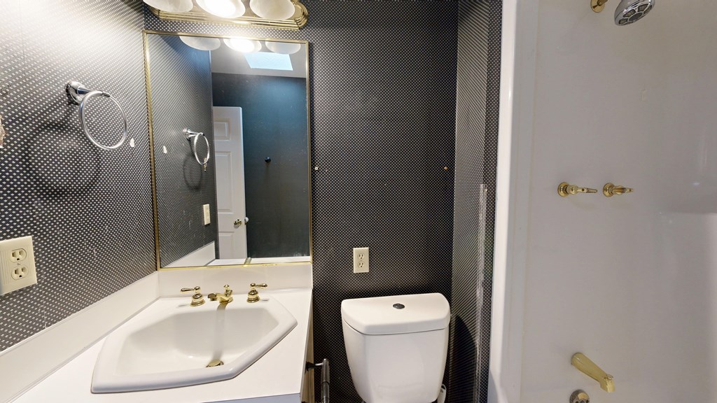 1237 Peacock Avenue Columbus, GA 31906 - Photo 41 of 52 a bathroom with a toilet sink and mirror