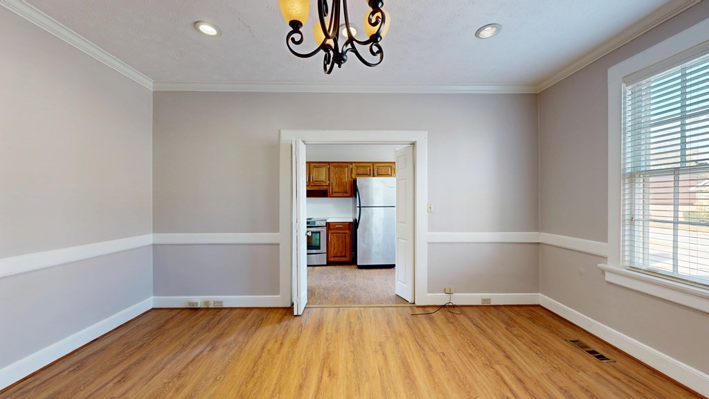 1237 Peacock Avenue Columbus, GA 31906 - Photo 7 of 52 an empty room with wooden floor and windows