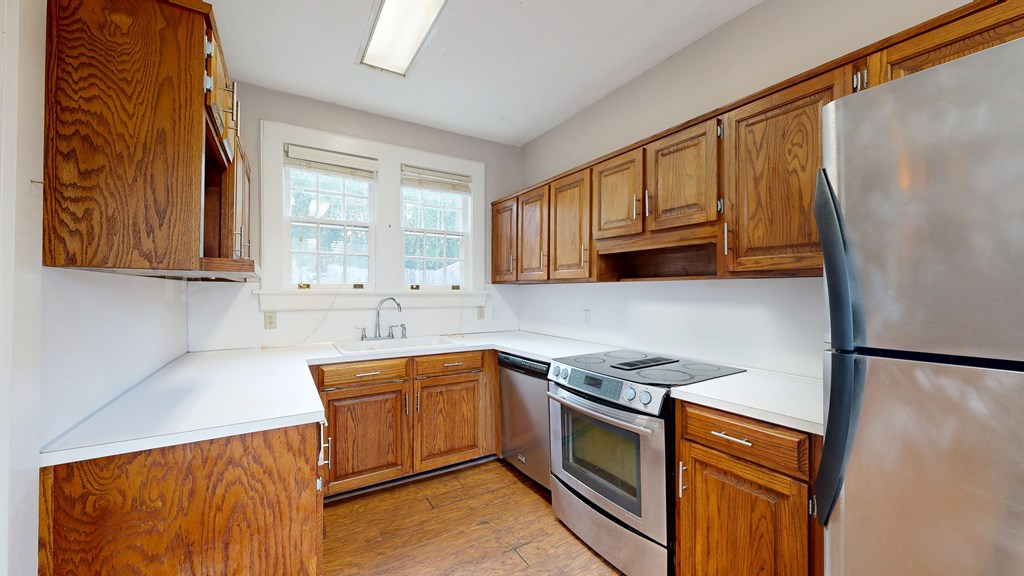 1237 Peacock Avenue Columbus, GA 31906 - Photo 10 of 52 a kitchen with stainless steel appliances granite countertop a sink stove and refrigerator