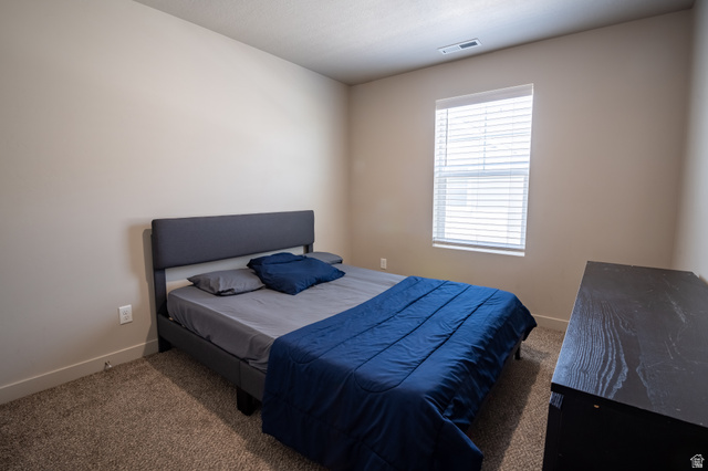 1787 North 1280 East Payson, UT 84651 - Photo 11 of 22 Neutral tone wall paint, window with blinds, recessed ceiling vent, low-pile carpeting, and white baseboards