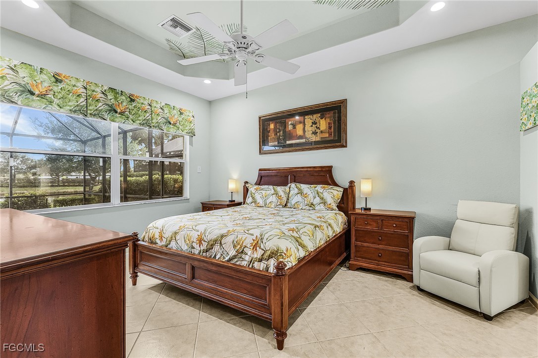 3900 Lakeview Isle Court Fort Myers, FL 33905 - Photo 14 of 31 a bedroom with a bed couch and window