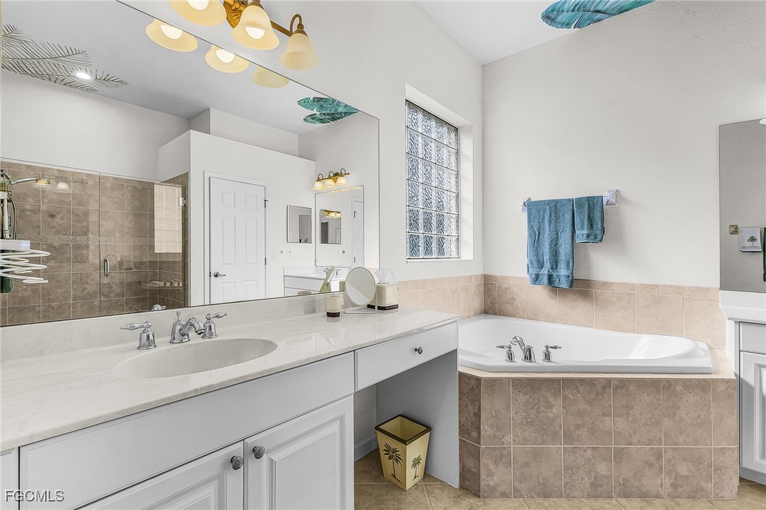 3900 Lakeview Isle Court Fort Myers, FL 33905 - Photo 16 of 31 a bathroom with a tub sink and mirror