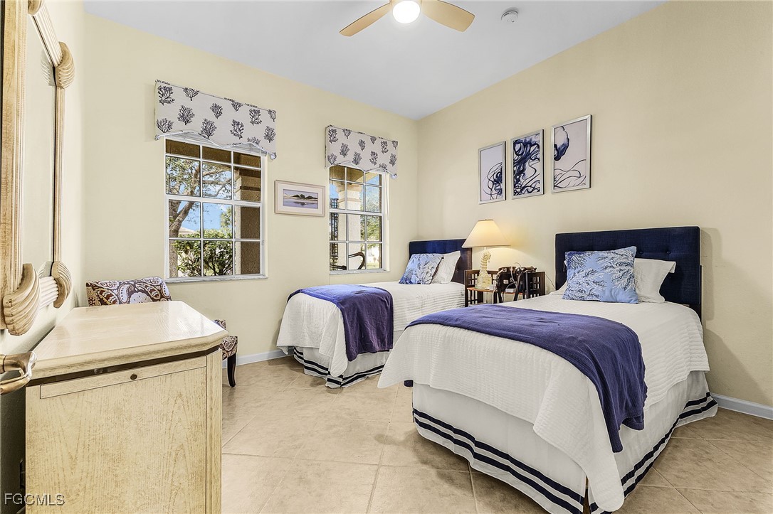 3900 Lakeview Isle Court Fort Myers, FL 33905 - Photo 21 of 31 a spacious bedroom with two beds and a chandelier