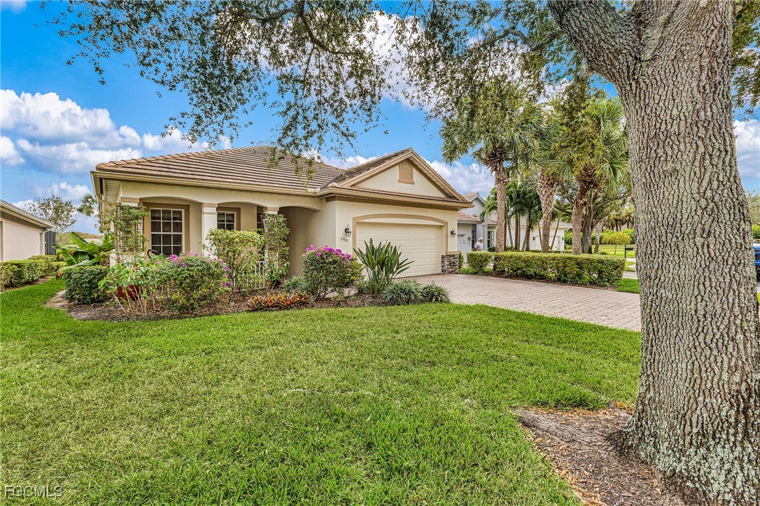 3900 Lakeview Isle Court Fort Myers, FL 33905 - Photo 3 of 31 a front view of a house with garden