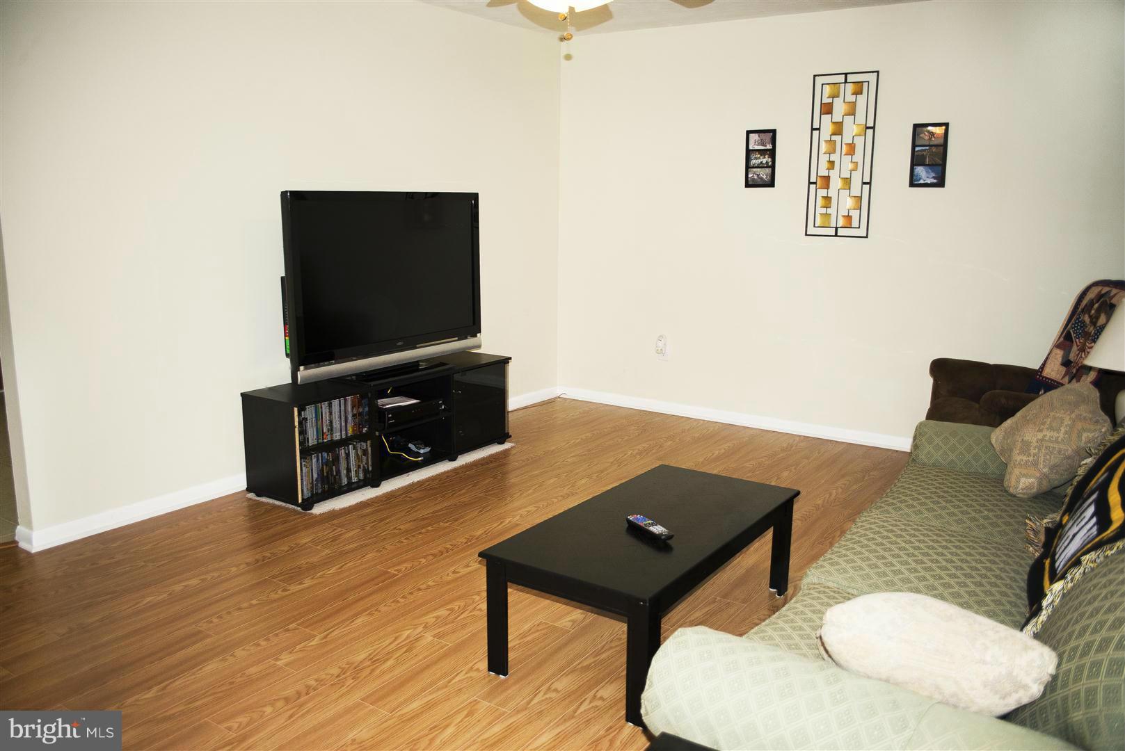 100 Valley Branch Drive Ranson, WV 25438 - Photo 7 of 8 a living room with furniture and a flat screen tv