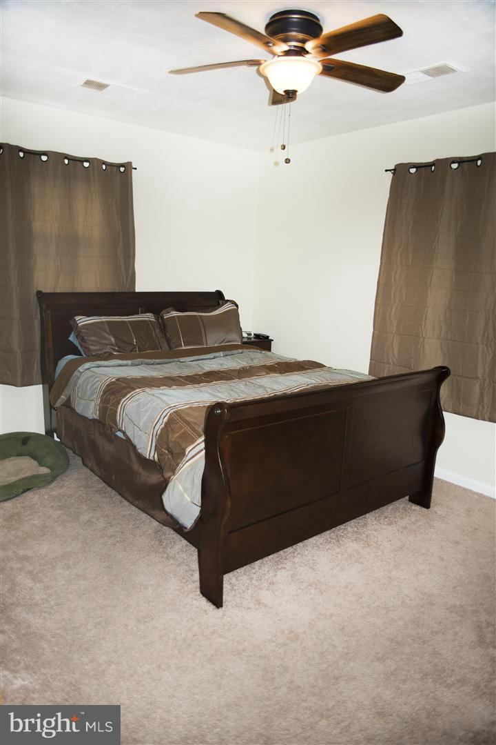 100 Valley Branch Drive Ranson, WV 25438 - Photo 8 of 8 a bedroom with a bed and a ceiling fan