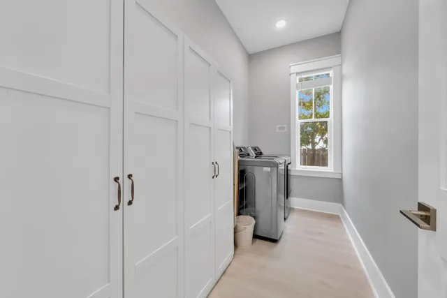 a kitchen with stainless steel appliances kitchen island a stove a refrigerator a sink dishwasher a dining table and chairs with wooden floor