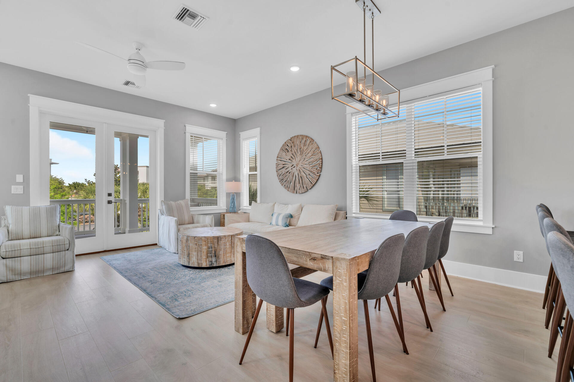50 West Blue Crab Loop Inlet Beach, FL 32461 - Photo 25 of 67 a dining room with wooden floor a chandelier a wooden table and chairs