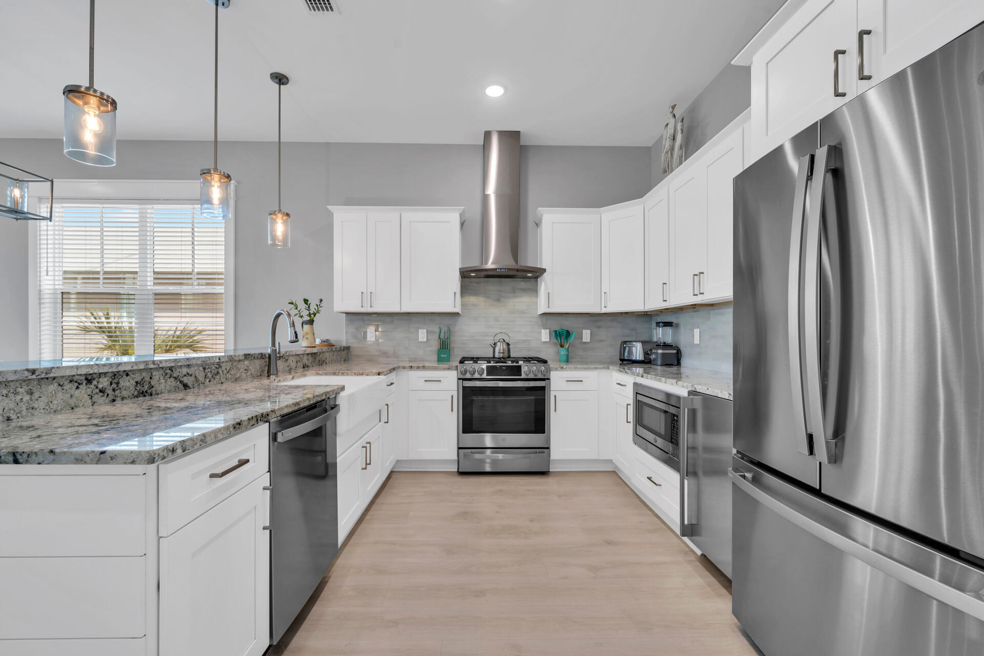 50 West Blue Crab Loop Inlet Beach, FL 32461 - Photo 30 of 67 a kitchen with stainless steel appliances granite countertop a stove a sink and a refrigerator