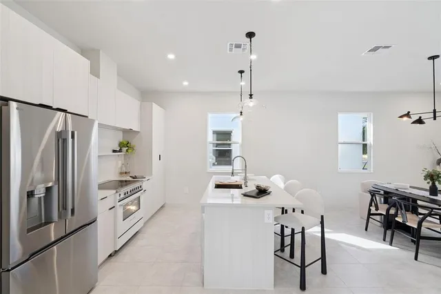 a kitchen with stainless steel appliances a refrigerator and a stove