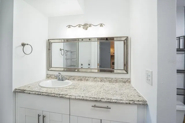 a bathroom with a shower and vanity