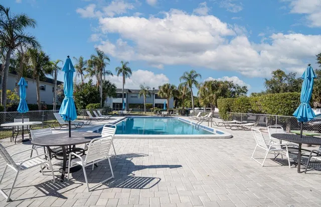 a swimming pool with outdoor seating and yard