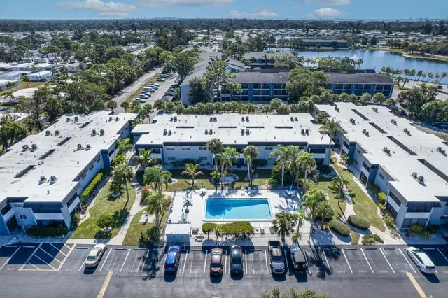 an aerial view of multi story residential building with outdoor space