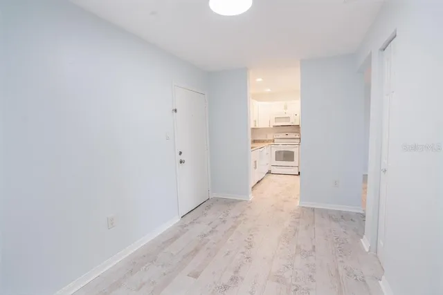 an empty room with closet and windows