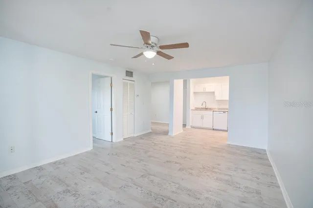 a kitchen with white cabinets and white stainless steel appliances