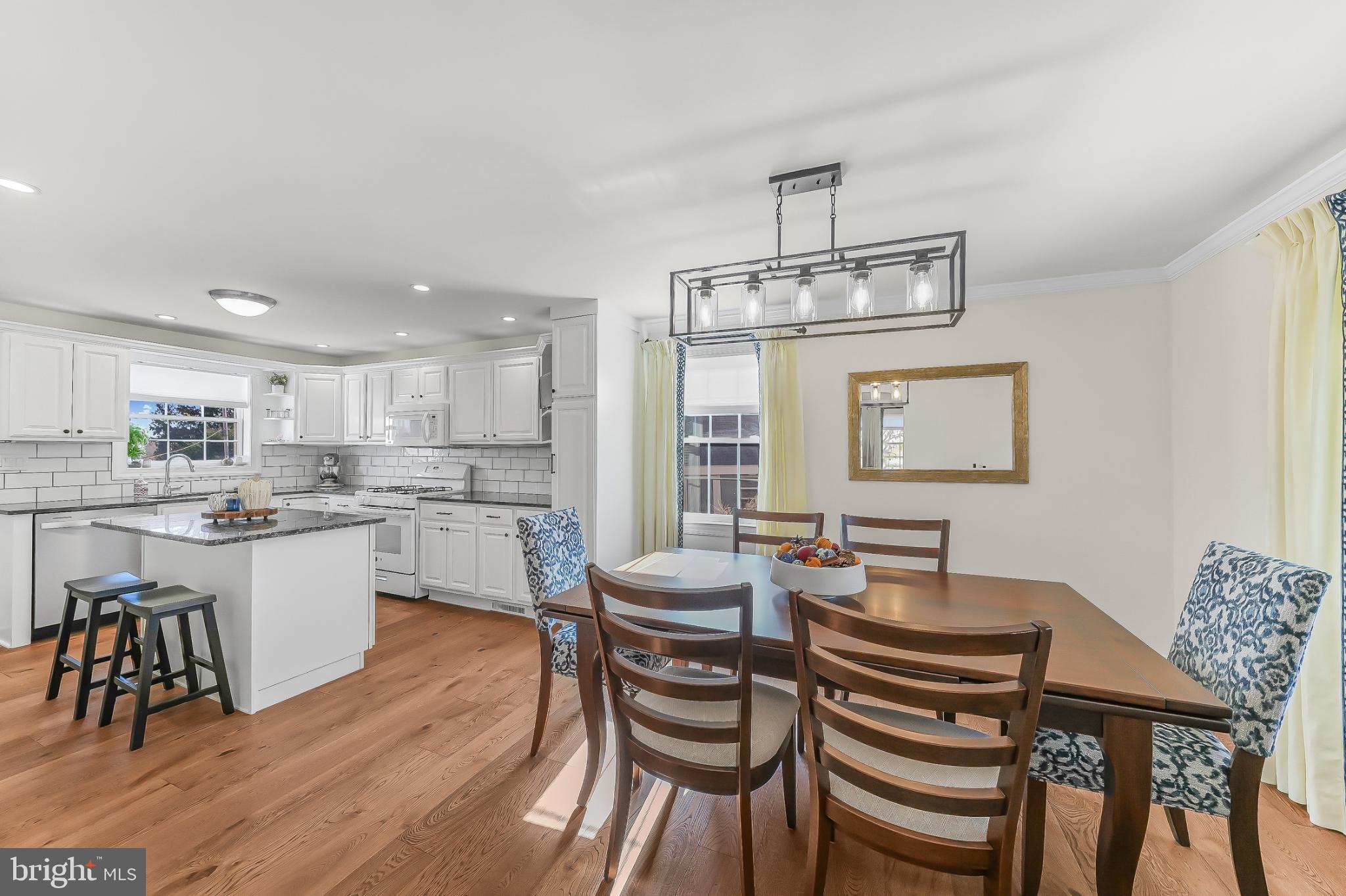565 Kirk Road Springfield, PA 19064 - Photo 13 of 41 a kitchen with a dining table chairs and microwave