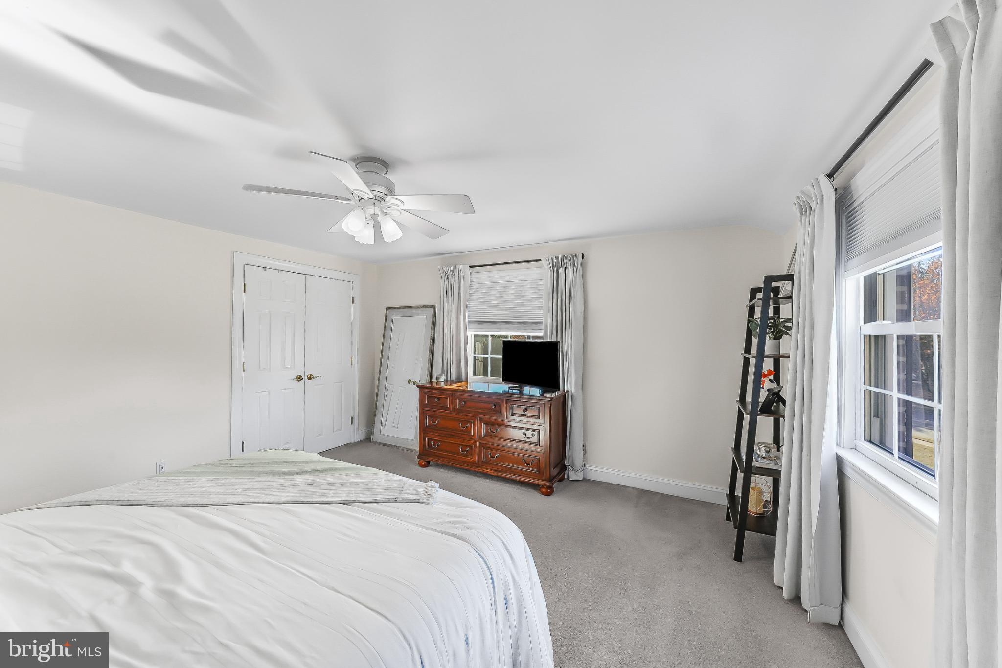 565 Kirk Road Springfield, PA 19064 - Photo 23 of 41 a bedroom with a large bed and a chandelier