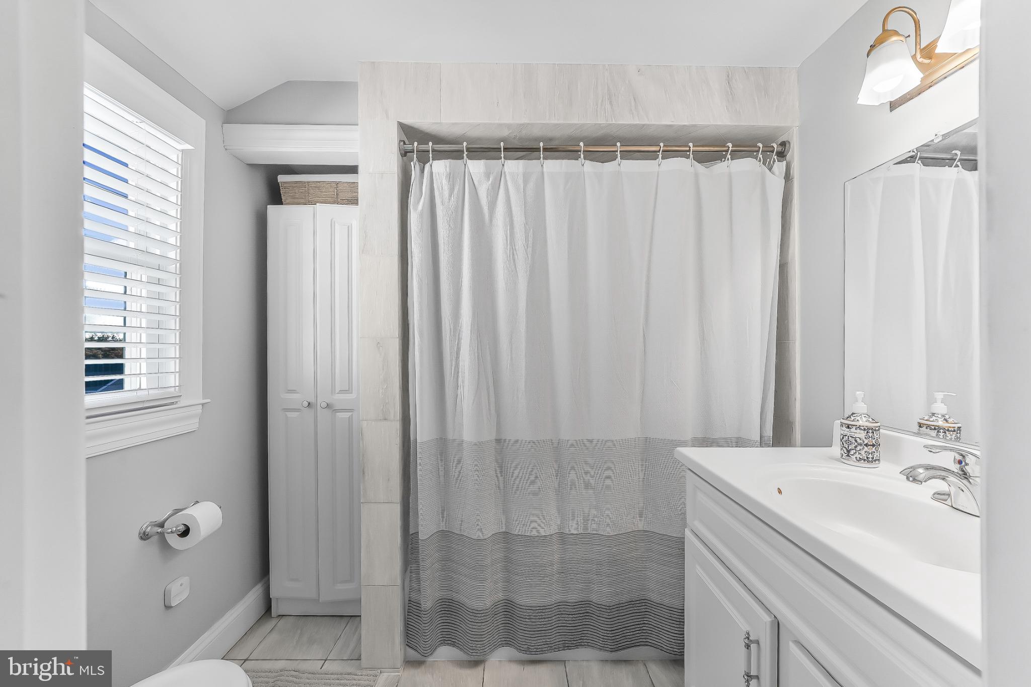 565 Kirk Road Springfield, PA 19064 - Photo 29 of 41 a bathroom with a sink a mirror and a shower