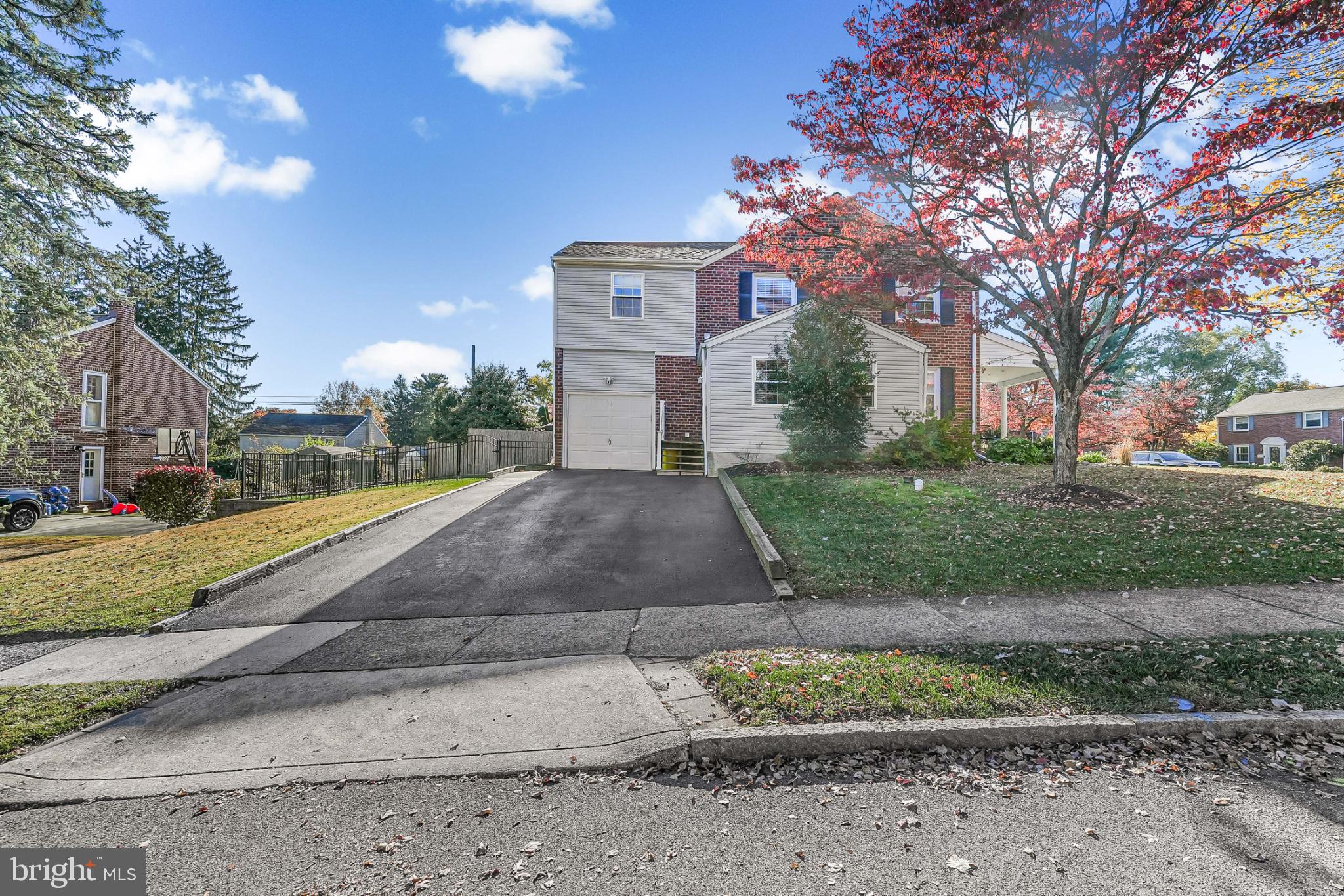 565 Kirk Road Springfield, PA 19064 - Photo 31 of 41 a view of a white house with a yard and plants