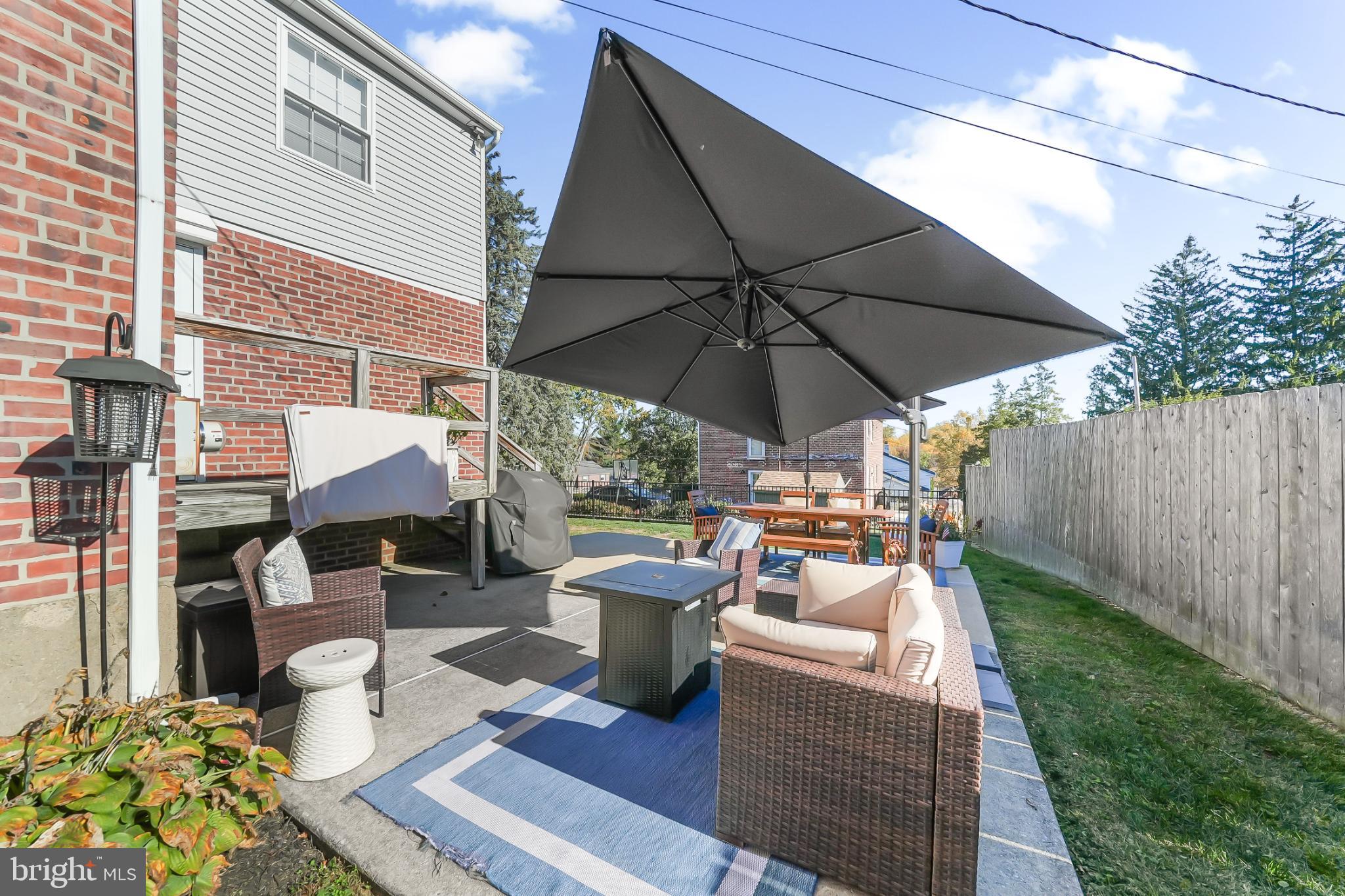 565 Kirk Road Springfield, PA 19064 - Photo 33 of 41 a view of a patio with furniture and a umbrella