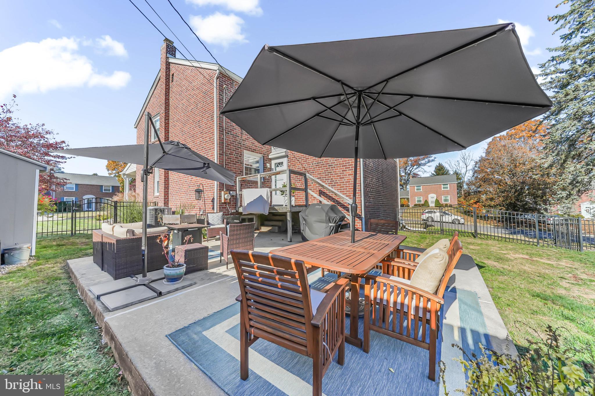 565 Kirk Road Springfield, PA 19064 - Photo 34 of 41 a view of a patio with a table chairs and a backyard