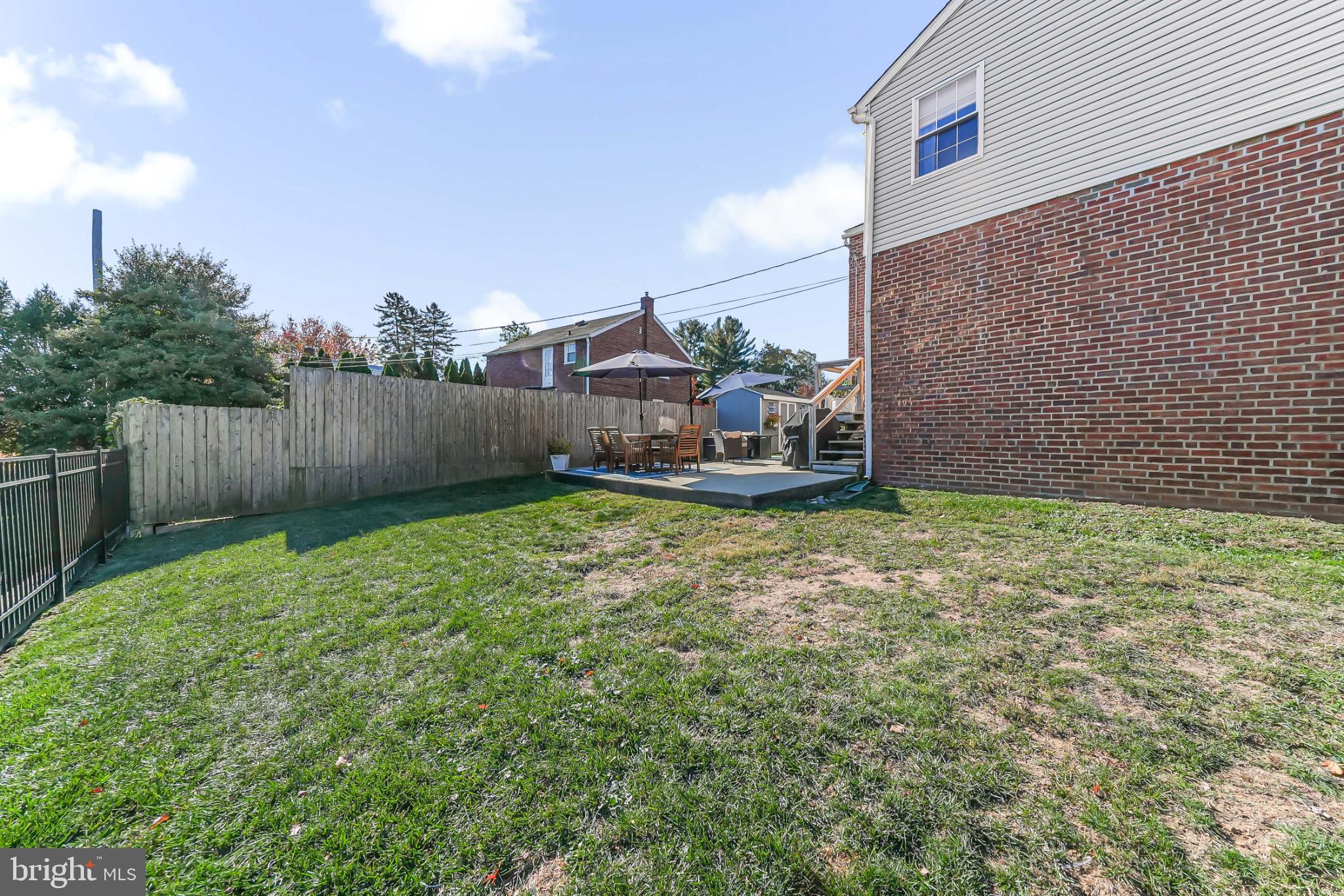 565 Kirk Road Springfield, PA 19064 - Photo 35 of 41 a view of a backyard with plants and wooden fence