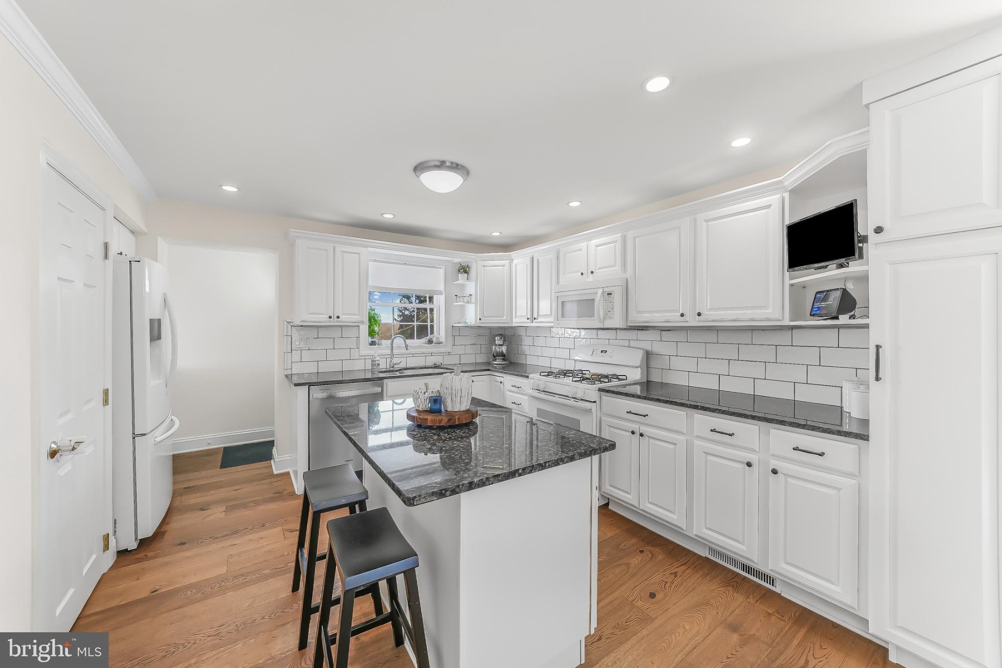 565 Kirk Road Springfield, PA 19064 - Photo 5 of 41 a kitchen with a sink a counter space appliances and cabinets