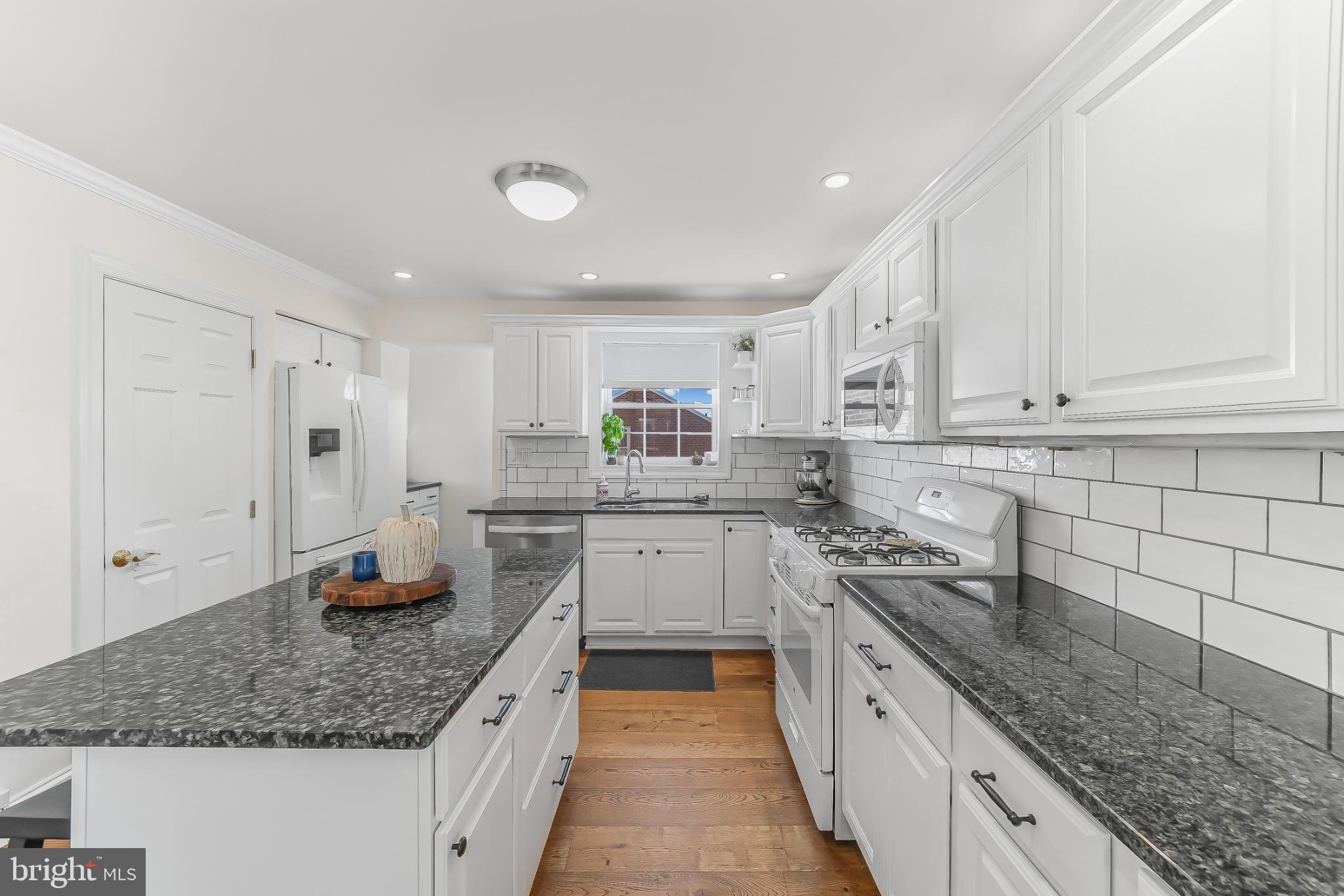 565 Kirk Road Springfield, PA 19064 - Photo 6 of 41 a kitchen with stainless steel appliances granite countertop a sink stove and cabinets