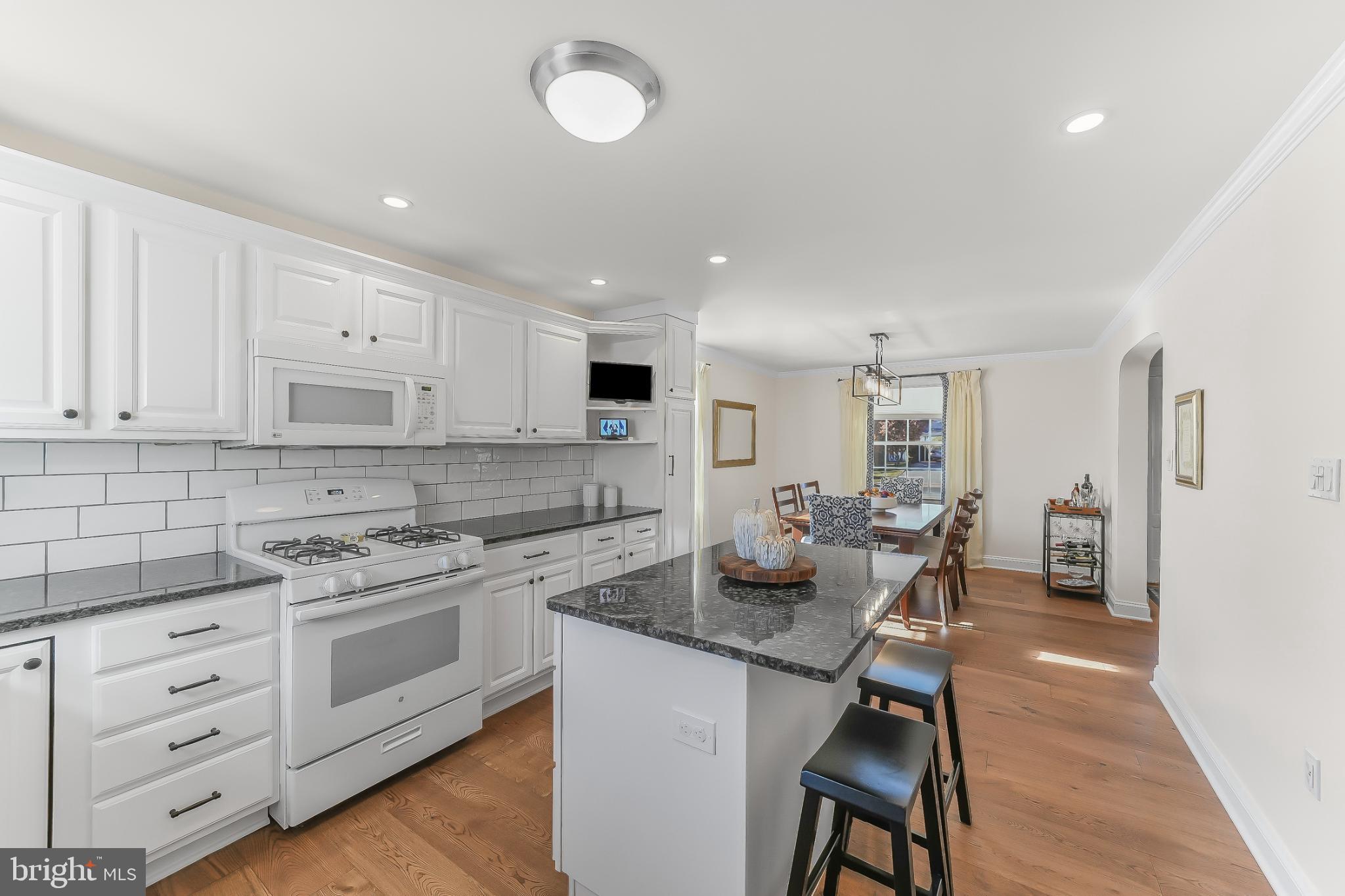 565 Kirk Road Springfield, PA 19064 - Photo 7 of 41 a kitchen with a white cabinets and chairs