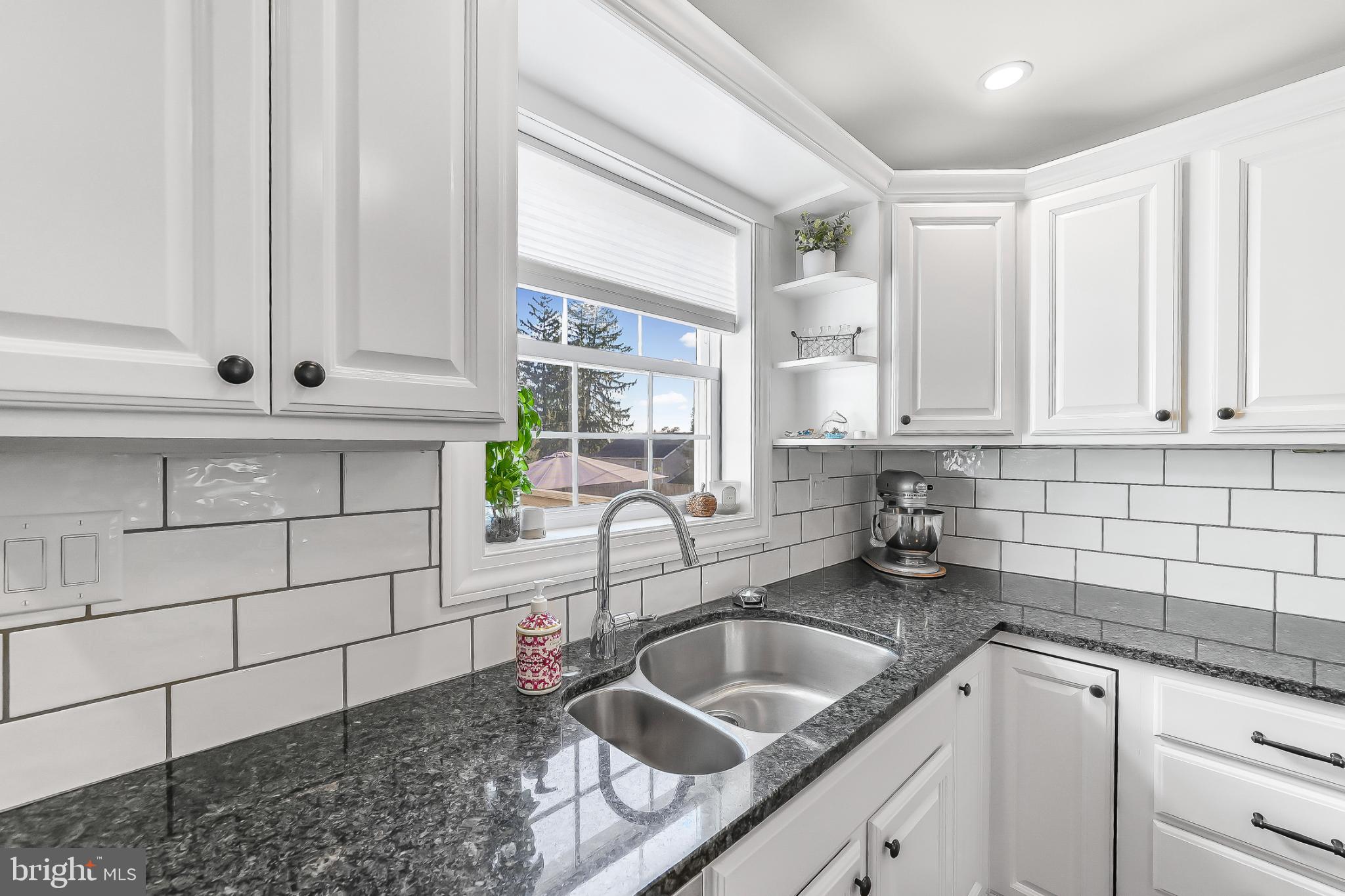 565 Kirk Road Springfield, PA 19064 - Photo 8 of 41 a kitchen with granite countertop a sink a stove and cabinets