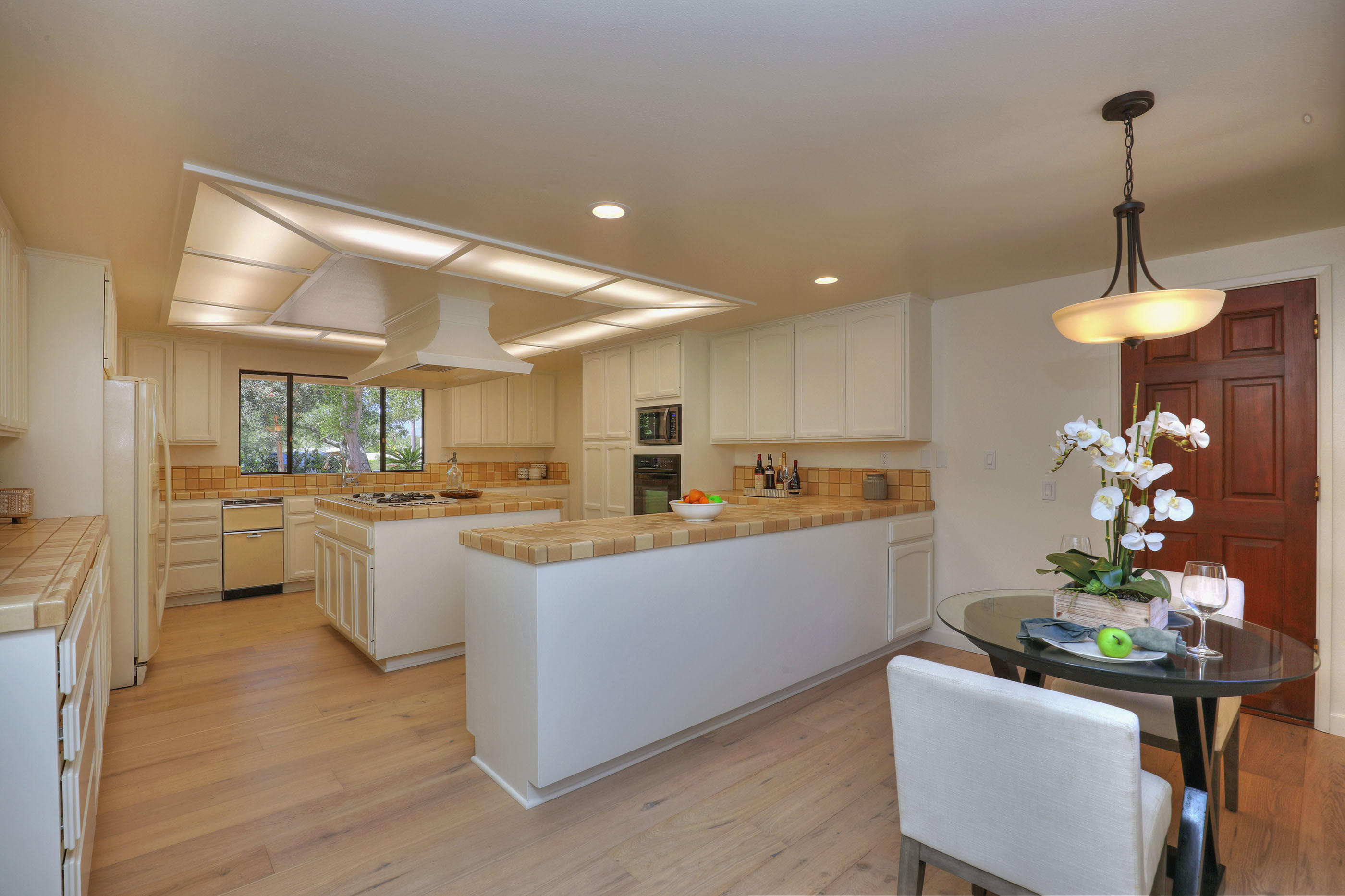 1674 Franceschi Road Santa Barbara, CA 93103 - Photo 9 of 25 a kitchen with kitchen island white cabinets and stainless steel appliances
