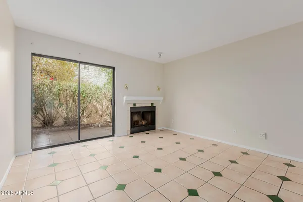 a view of an empty room with a fireplace