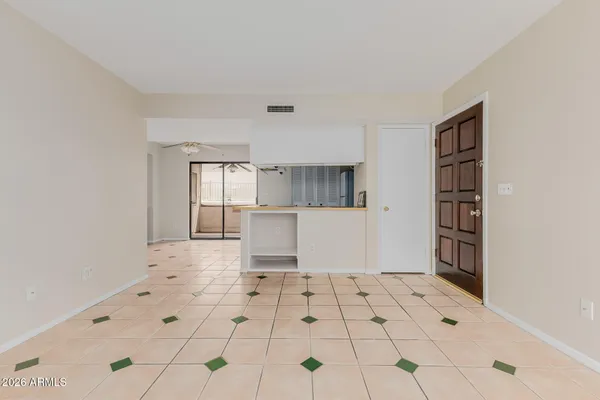 a view of kitchen with furniture and refrigerator