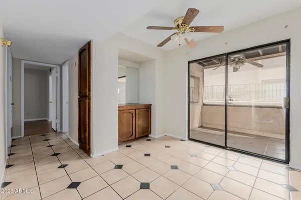 a living room with a large mirror and glass door