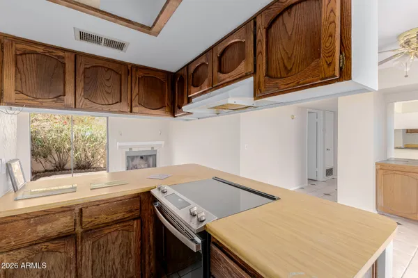 a kitchen with stainless steel appliances granite countertop a sink and cabinets with wooden floor