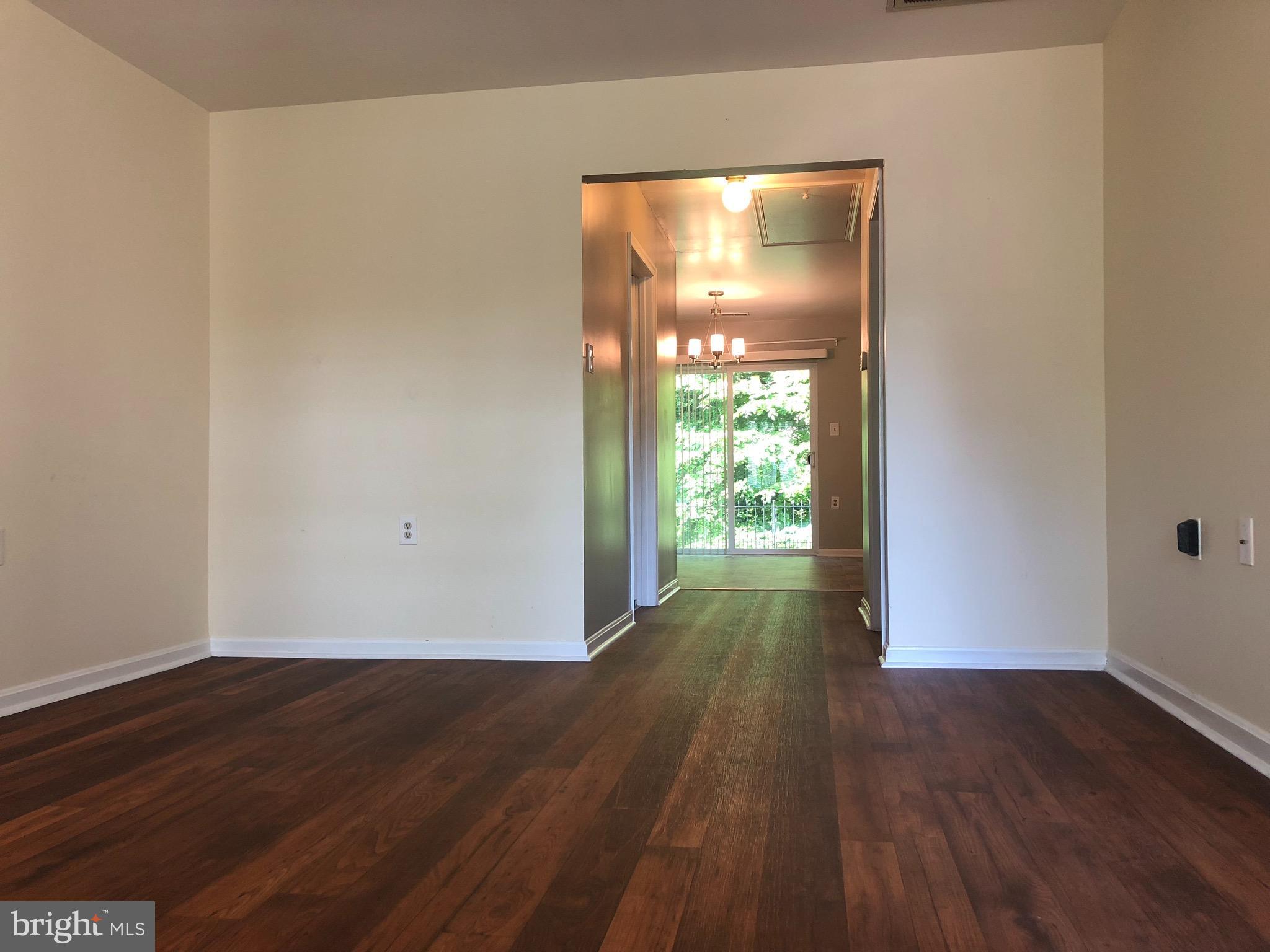 974 Riversedge Circle Annapolis, MD 21401 - Photo 2 of 9 a view of empty room with wooden floor and fan