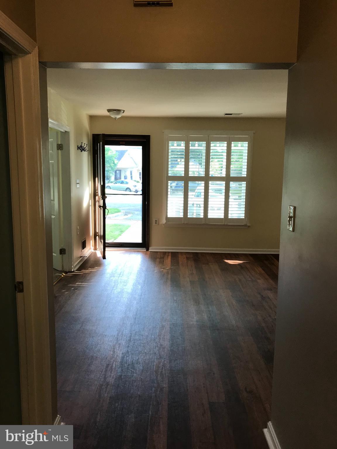 974 Riversedge Circle Annapolis, MD 21401 - Photo 3 of 9 an empty room with wooden floor and windows