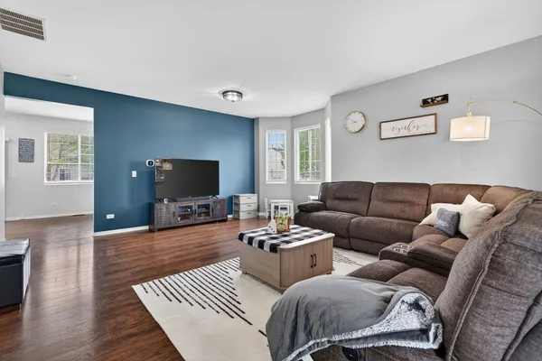a living room with furniture a rug and a flat screen tv