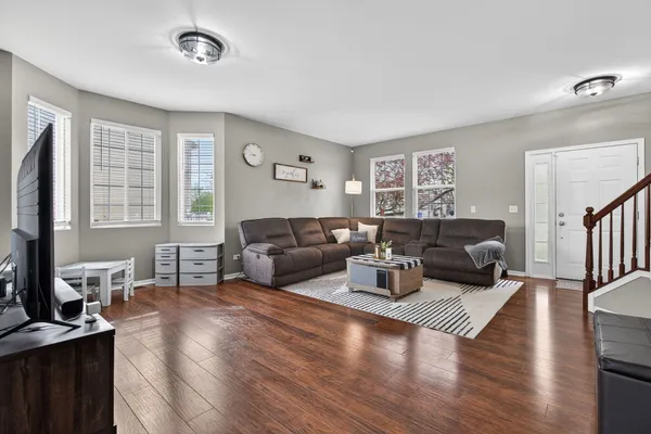 a living room with furniture wooden floor and a flat screen tv