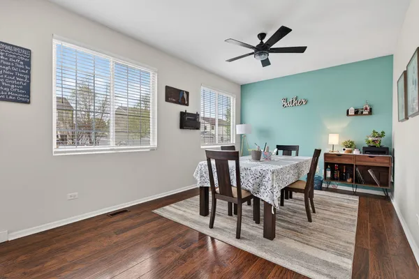 a view of a dining room with furniture and wooden floor